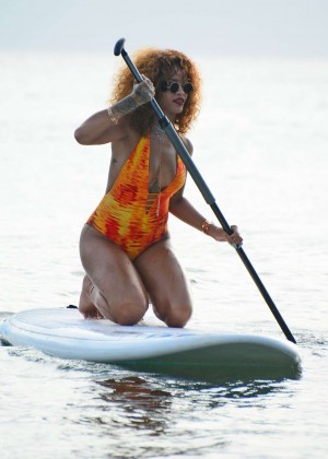 Rihanna in Orange Swimsuit Paddleboarding in Barbados
