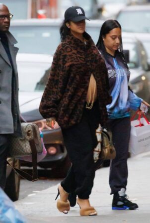 Rihanna - Shows her baby bump in a leopard coat as she returns to New York