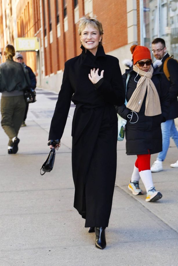 Robin Wright - In a black trench coat and knee long boots in New York