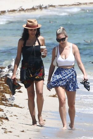 Rosario Dawson - Seen at the beach alongside a gal pal in Miami