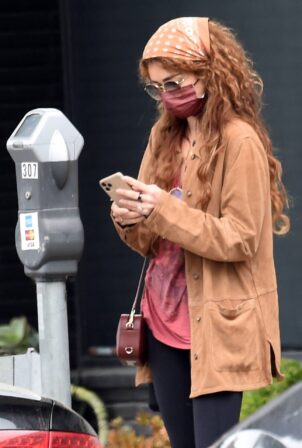Sarah Hyland - feeds the parking meter in West Hollywood