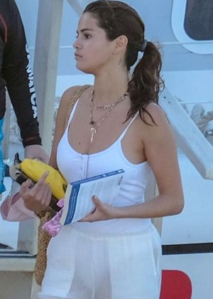 Selena Gomez in White Swimsuit and Pants at a pool and sailing in Montego Bay