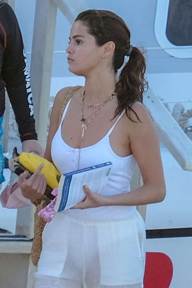 Selena Gomez in White Swimsuit and Pants at a pool and sailing in Montego Bay