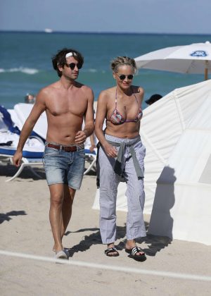 Sharon Stone in Bikini Top with her boyfriend at the beach in Miami