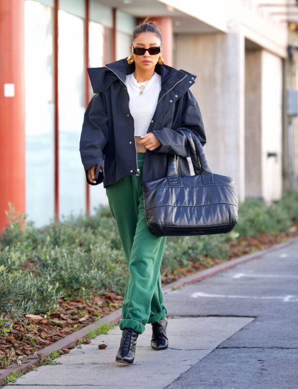 Shay Mitchell - Wearing Sarah Jessica Parker style rolled up sweatpants with heeled boots in LA