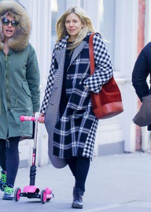 Sienna Miller wears a plaid coat out in New York City