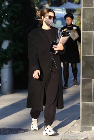 Sofia Richie - shopping for holiday wrap in all black ensemble