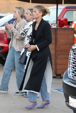 Sofia Richie - Wearing a black trench coat with blue jeans in Malibu