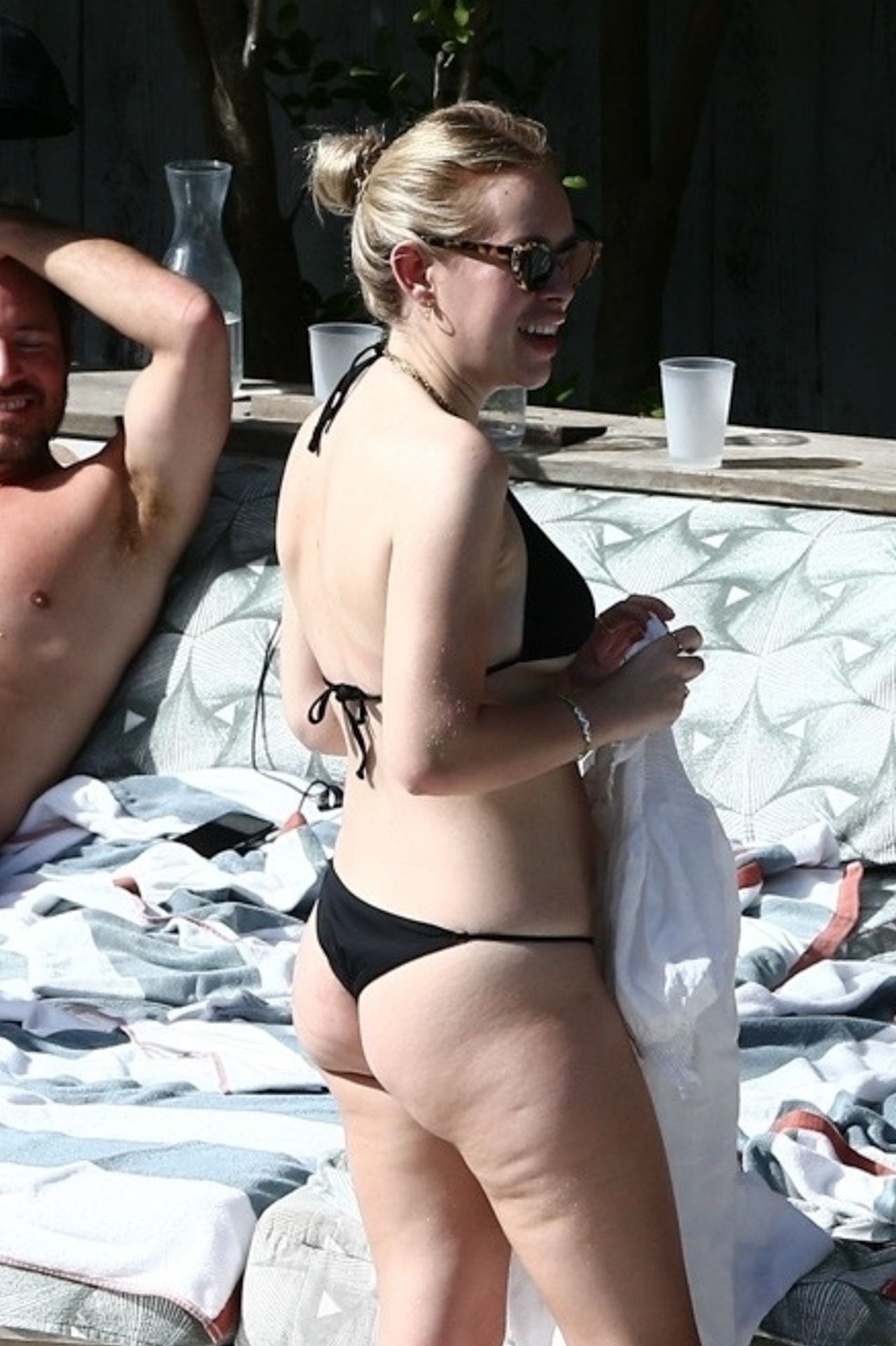 Tanya Burr â€“ In a black bikini by the pool in Miami