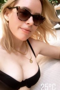 Tanya Burr - In a black bikini by the pool in Miami