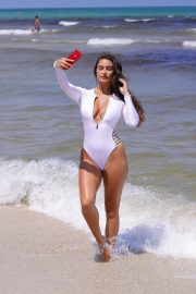 Tao Wickrath in White Swimsuit on the beach in Miami