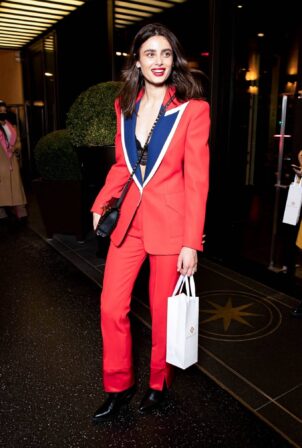 Taylor Hill - In a red suit exits the Bulgari Hotel during fashion week in Paris