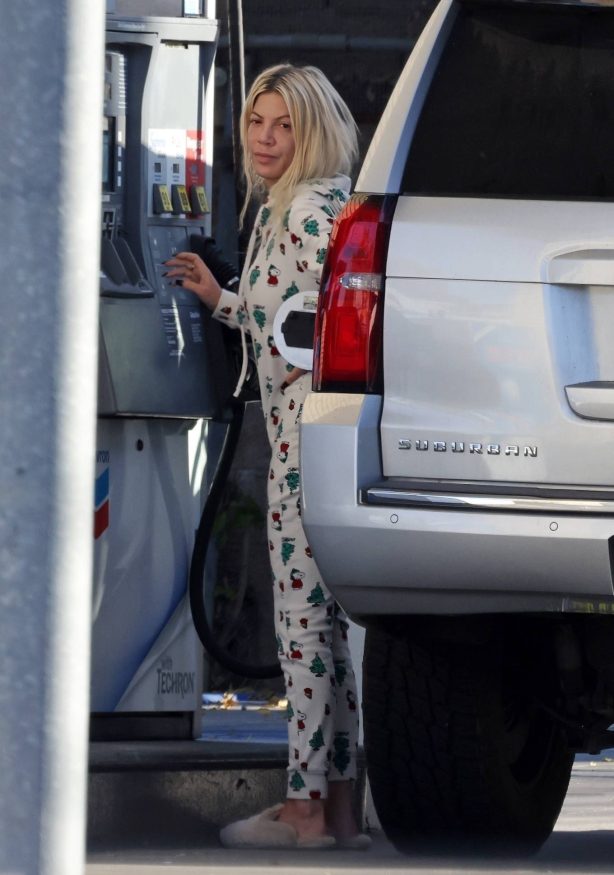 Tori Spelling - Pumping gas in a Snoopy-themed Christmas onesie in Woodland Hills