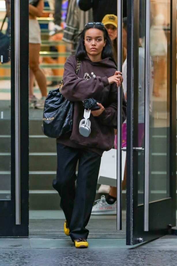 Whitney Peak - In a brown oversized hoodie and a Chanel bag seen in New York